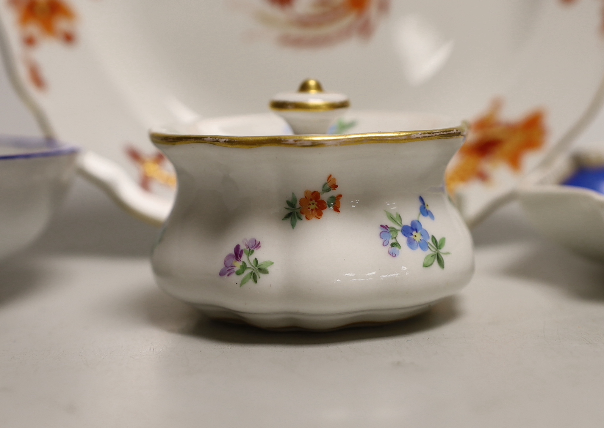 Four Meissen porcelain items including a plate, two small outside decorated dishes and a miniature lidded pot, plate 18cm